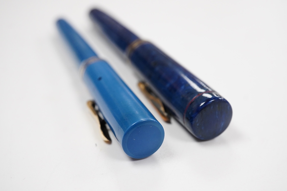 Two Conklin Enoura fountain pens in lapis blue (Senior) and a pale blue example
